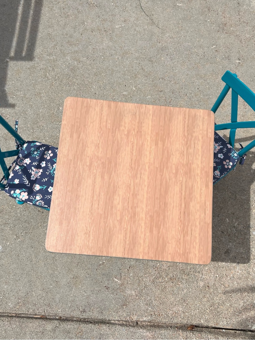 American Girl Teal Chairs with Navy Floral Cushions and Light Wood Table